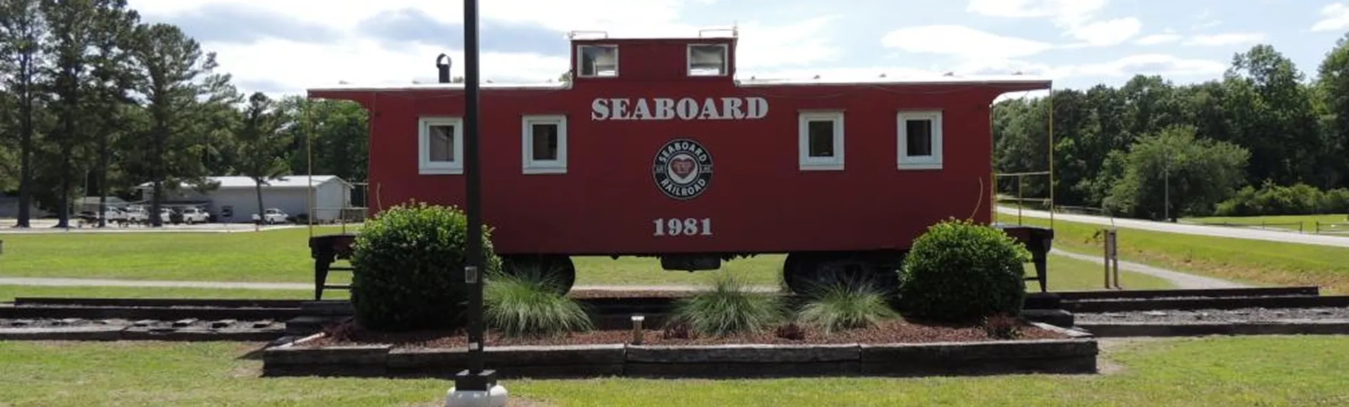 A vintage train compartment featuring the words "Seaboard Railroad 1981" on its exterior, suggesting it is part of the historic Seaboard rail line.